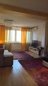 a living room with a couch and a television at Rezevici AZUR in Budva