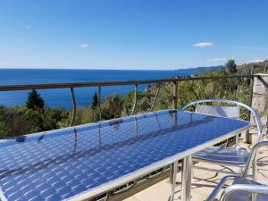 a blue table and chairs on a balcony with the ocean at Rezevici AZUR in Budva