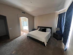 a bedroom with a white bed and a window at Goodyear Cul-De-Sac Master Bedroom in Goodyear