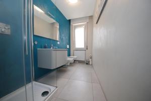 a bathroom with a shower and a sink and a toilet at Il Cortiletto - Cozy Apt Brand New Equipped Private Garden - BBQ in Como +24 photos