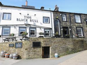 a brick building with the black bull on it at Hivewood Cottage in Keighley