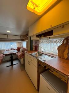 a kitchen with a couch and a table in a room at Les Hulottes in Le Vrétot +23 photos