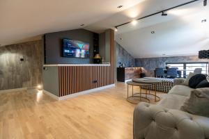 a living room with a couch and a tv at Apartments AMALFI Old Town FREE Parking in Sarajevo