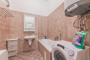 a bathroom with a washing machine and a sink at Heart of Prague Lodgings 7 in Prague