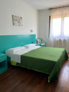 Postel nebo postele na pokoji v ubytování Hotel Verdeneve