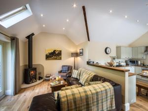 a living room with a couch and a fireplace at 2 Bed in Baslow SKN18 in Baslow