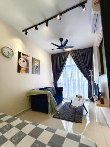 a living room with a blue couch and a ceiling fan at Midas Brand New Modern Vintage 1BR 2-5pax in Masai