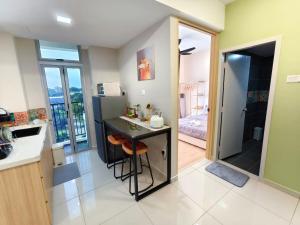 a kitchen with a counter and a sink and a refrigerator at Midas Brand New Modern Vintage 1BR 2-5pax in Masai