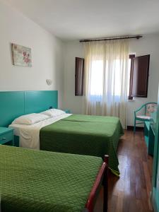 Postel nebo postele na pokoji v ubytování Hotel Verdeneve
