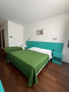 Postel nebo postele na pokoji v ubytování Hotel Verdeneve