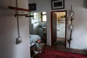 a bedroom with a bed and a room with a mirror at The Little Gallery in Villiersdorp