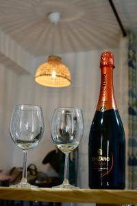 a bottle of wine and two wine glasses on a table at Cozy Seaside Apartment in Cullera in Cullera