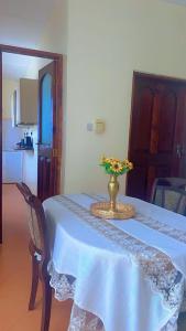 a table with a vase of flowers on top of it at Malkiya house in Zanzibar City