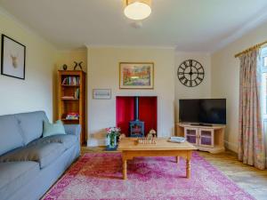 a living room with a blue couch and a coffee table at 3 Bed in Blairgowrie 90111 in Blairgowrie