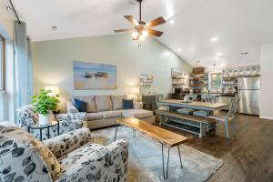 a living room with a couch and a table at Retreat by Design - Resort Amenities in Branson West