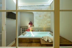 a bath tub in a bathroom with a window at Lafornara Suite in Martina Franca +70 photos