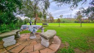 a picnic table and bench in a park at Rivers Edge Loft in Wellington