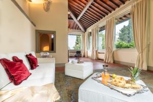 a living room with a white couch and red pillows at Villa Loretino I Ultimate Luxury in Florence in Comeana