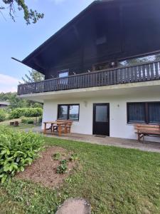 een gebouw met twee banken ervoor bij Ferienwohnung Natalia in Thalfang