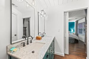 a bathroom with a sink and a large mirror at River Cottage in Gatlinburg +48 photos