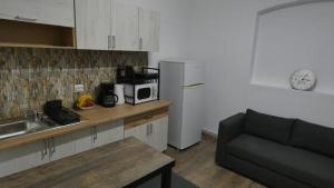 a kitchen with a sink and a refrigerator and a couch at Take a Break in Braşov