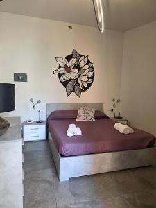 a bedroom with a bed with two towels on it at Beautiful Naxos House in Giardini Naxos