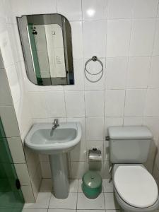 a bathroom with a sink and a toilet and a mirror at Hotel Aeroporto de Congonhas in Sao Paulo