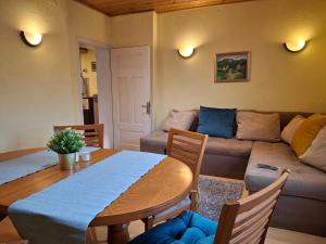 a living room with a table and a couch at The Old Cherry House in Razlog