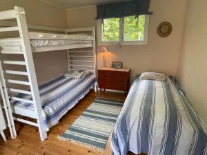 a bedroom with two bunk beds and a window at 7 person holiday home in RAMDALA in Möcklö