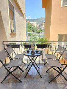 a patio with a table and chairs on a balcony at Beautiful Naxos House in Giardini Naxos