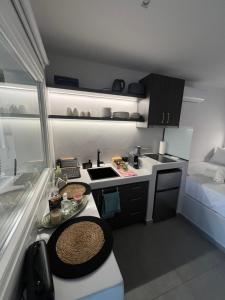 a small kitchen with a table with food on it at The wave in Kardhianí