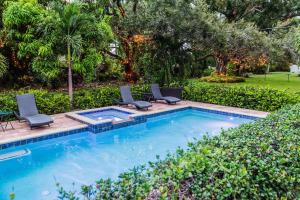 a swimming pool with two lounge chairs and a swimming pool at Family 4 Bedroom 3 Bathroom Pool Home with Huge Yard in Bradenton