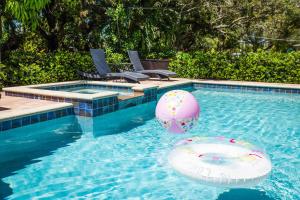 a swimming pool with a beach ball in the water at Family 4 Bedroom 3 Bathroom Pool Home with Huge Yard in Bradenton