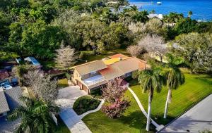 an aerial view of a house with trees and the ocean at Family 4 Bedroom 3 Bathroom Pool Home with Huge Yard in Bradenton +38 photos