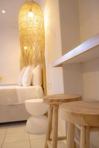 a room with a bed and a table and two benches at Mairyren in Ano Syros +13 photos
