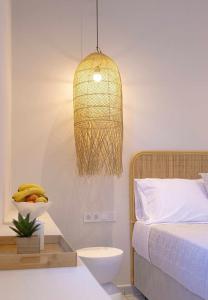a bedroom with a bed and a pendant light at Mairyren in Ano Syros