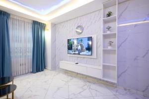 a living room with a tv on a wall at Executive Studio Apartment, East Airport in Accra