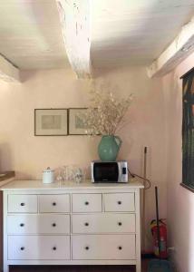 a white dresser with a vase on top of it at Country House Ca di siro in Gazola