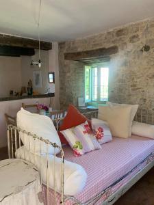 a bedroom with a bed with pillows on it at Country House Ca di siro in Gazola