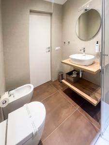 a bathroom with a sink and a toilet and a mirror at Casa Almika Abate Gimma in Bari +58 photos