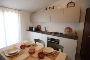 a kitchen with a table with chairs and a stove at Sweet Orange in Ispica