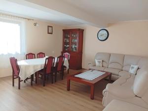 a living room with a table and a couch at Stramówka in Groń
