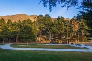 a picnic shelter in a park with mountains in the background at Oaks at Wasatch #5 in Cottonwood Heights