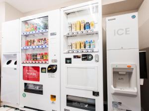 an ice machine in a room with two refrigerators at Meitetsu Inn Hamamatsucho in Tokyo