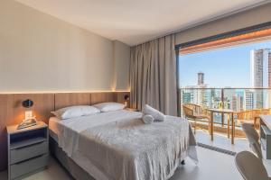 a hotel room with a bed and a balcony at Beach Class Meireles #1505 Vista Mar By Carpediem in Fortaleza +20 photos