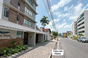 a street with a sign on the side of a building at Studio Luxo 150m Praia Intermares 3 Pessoas in Ilha da Restinga