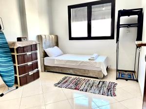 a bedroom with a bed and a window and a rug at Appart G7 loca in Agadir