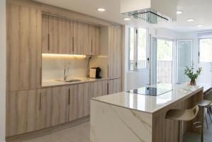 a kitchen with wooden cabinets and a counter top at Aromes d'Espadà in Eslida