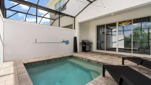 a swimming pool in the middle of a house at Upstay Pristine 3BR Home with Private Pool & BBQ in Orlando