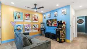 a living room with a blue and yellow wall at Upstay Pristine 3BR Home with Private Pool & BBQ in Orlando +29 photos
